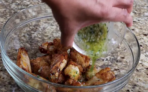 Coating the garlic parmesan wings